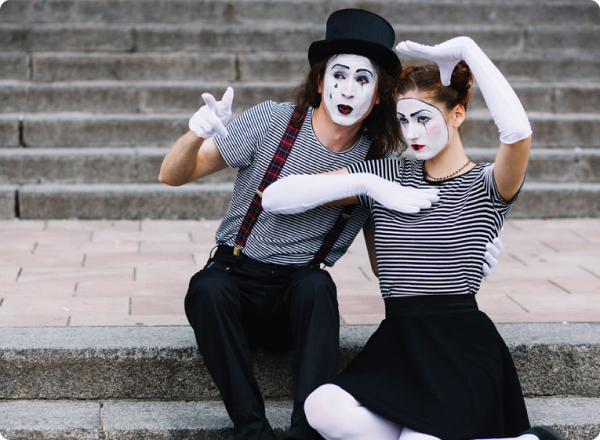 Image of a clown with a hat and traditional clown makeup